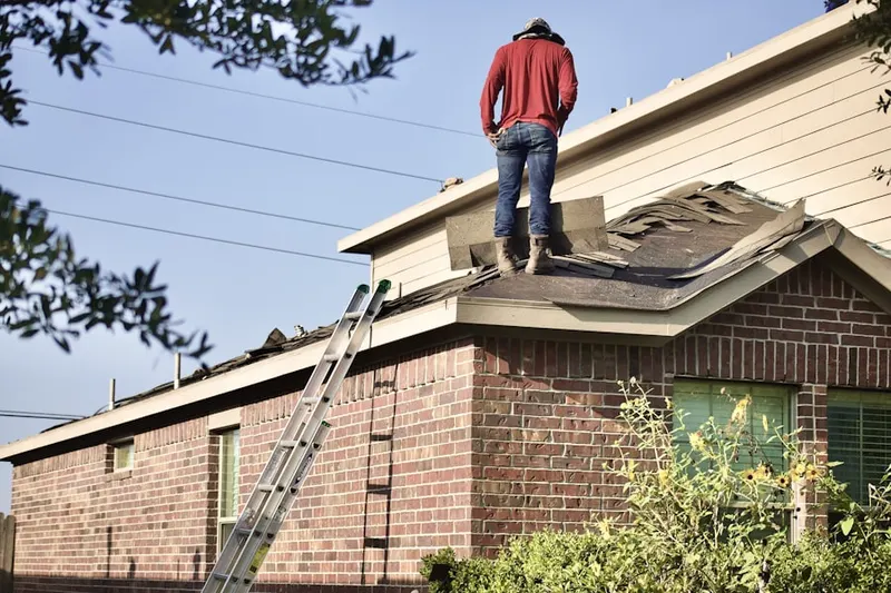 Professional roofer working on a residential roof in Childress